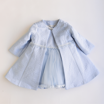 Light blue girls’ formal coat with textured fabric, lace trim at the waist, and sheer tulle dress peeking underneath, ideal for special occasions.