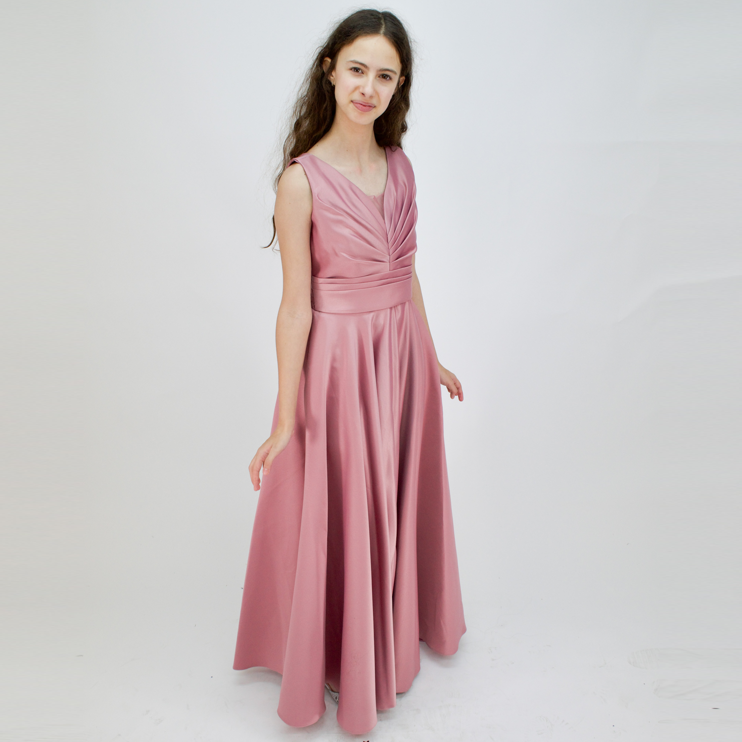 A young woman wearing a sleeveless floor-length pink satin dress