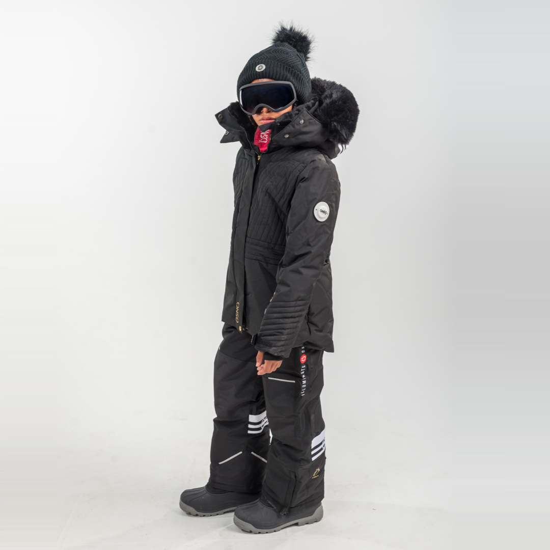 Person wearing a black winter coat and pants on a white background