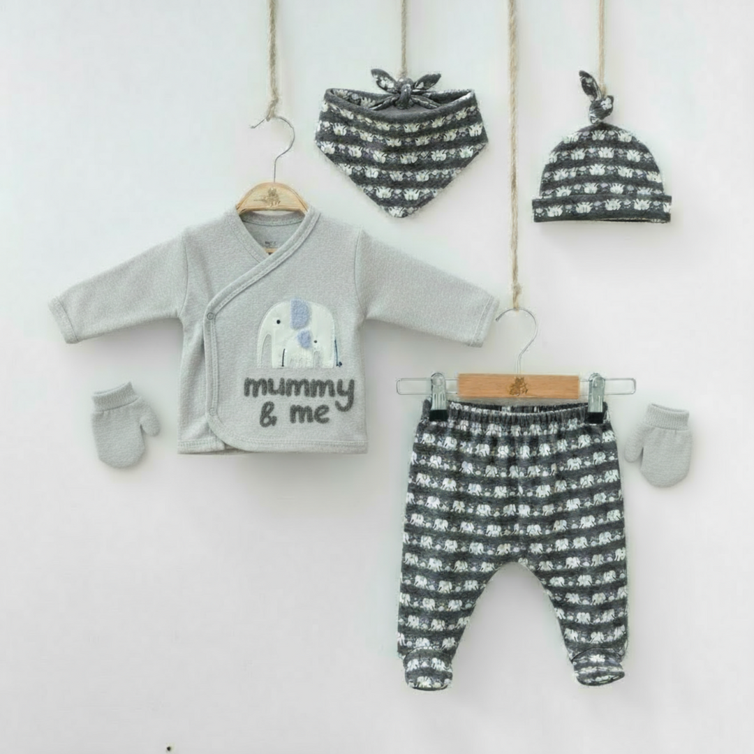 Grey baby outfit set with elephant-print top, matching pants, hat, bib, and mittens arranged on hangers.